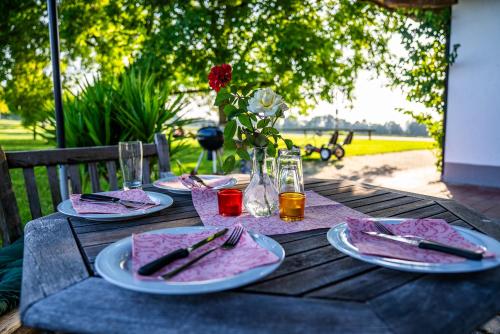 a wooden table with plates of food on it at Thalerbauer Ferienwohnungen in Wackersberg