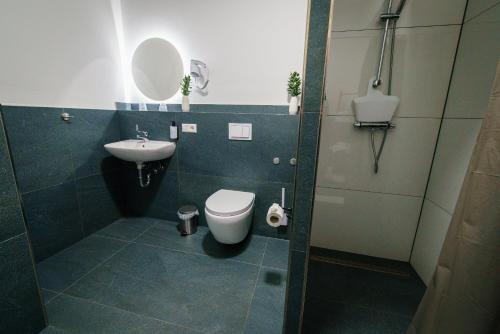 a bathroom with a toilet and a sink at Hotel Waibstadter Hof in Waibstadt