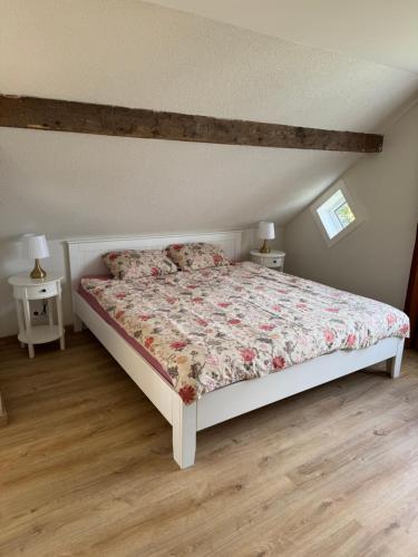 a bedroom with a bed and two night stands at White Sand Studio in Pāvilosta