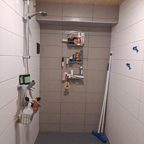 a bathroom with a shower with a rack on the wall at Niittytie Alexsandra in Kuopio