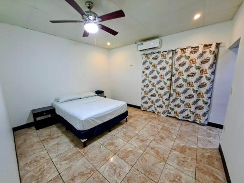 a bedroom with a bed and a ceiling fan at Casa Isabella 54 Enjoy with family and friends in Matagalpa