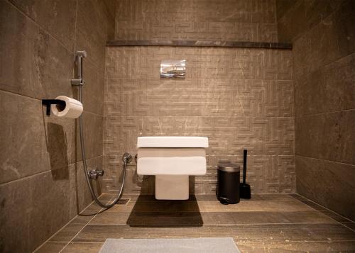 a bathroom with a toilet and a shower stall at Luxury Rooms in the Heart of Pyramids in Kafr Ghaţāţī