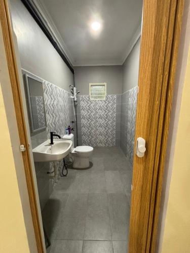 a bathroom with a toilet and a sink at home inap in Kampong Bukit Badong