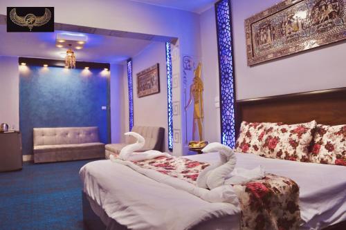 a bedroom with a bed with swans on it at Comfort Inn Pyramids Hotel in Cairo