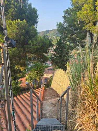 a set of stairs leading down a hill with trees at Can Marisu in Cabrils