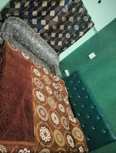 a close up of a tie on a bed at RAJWADA Hotel in Gangānagar