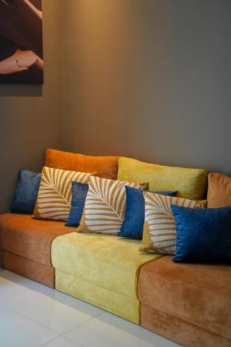 a couch with pillows on it in a room at Maison Miraj Hostel in Muscat