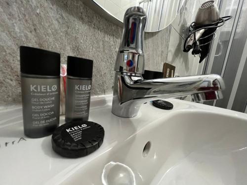 a bathroom sink with keco products sitting on it at D'Aversa Rooms in Marineo