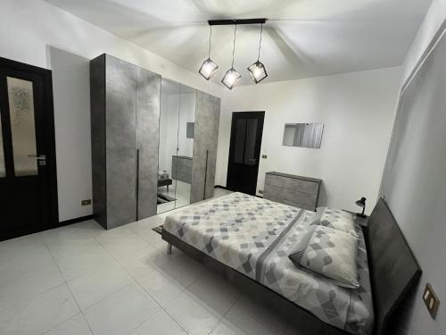 a bedroom with a large bed and a bathroom at D'Aversa Rooms in Marineo