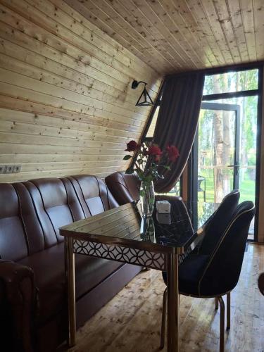 a living room with a couch and a glass table at Zovaber hangsti goti in Sevan