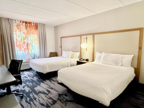 a hotel room with two beds and a window at Fairfield Inn & Suites by Marriott Knoxville/East in Knoxville