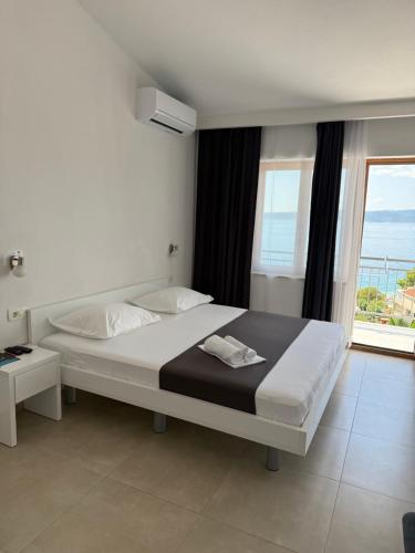 a bedroom with a bed with a view of the ocean at Berulia accommodation in Brela