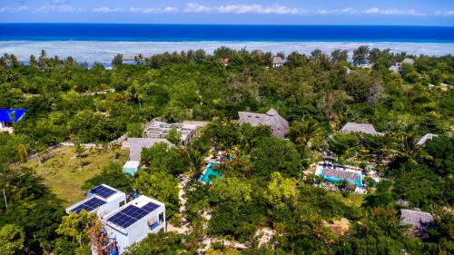 an aerial view of a resort with a pool and the ocean at Kameleon Blue in Kizimkazi