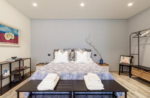 a bedroom with a large bed with two chairs at Loftino42 - Monolocale Open Space a Ferrara, Biciclette incluse in Ferrara