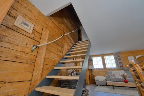 a staircase in a house with wooden walls at Les Mayens in Leysin