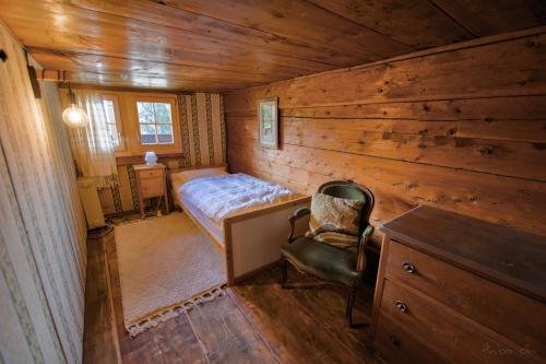 a bedroom with a bed and a desk and a chair at Les Mayens in Leysin