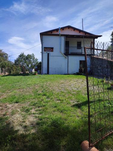 a house with a fence in front of a field at CASA VACANZA Da GIOVANNI in Masseria di Rusciano