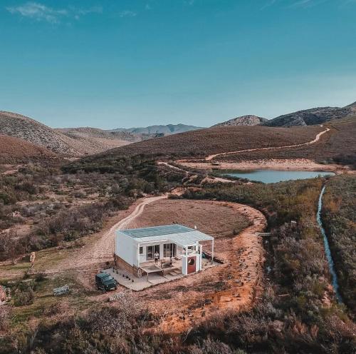 an aerial view of a tiny house in the middle of a field at White Stone Retreat in Oudtshoorn
