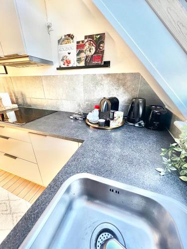 a kitchen with a sink in the middle of a counter at No3 VB Apartment in Vejle