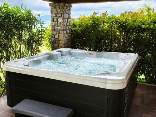 a hot tub sitting on a patio at Villa Dol an ideal spa and wellness escape in Istria in Buzet