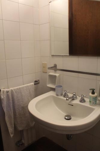 a bathroom with a sink and a mirror and towels at Villetta Cristina historic village Bellano-LC Comolake in Bellano