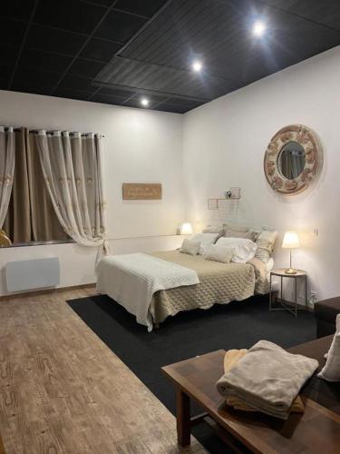 a bedroom with two beds and a table and a couch at The Corner Pavillon in Noirmoutier-en-l'lle