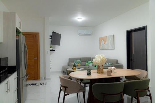 a living room with a table and a couch at luxury apartment in punta cana in Punta Cana