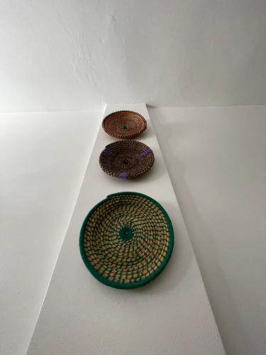 three donuts sitting on a shelf in a room at Island surf house in Imsouane