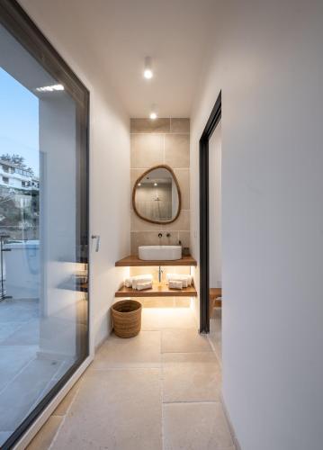 a bathroom with a sink and a mirror at Trame Suites in San Vito Chietino