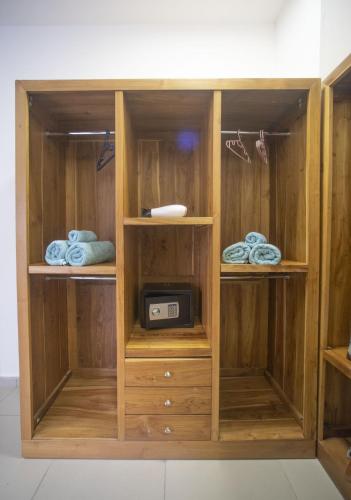 a wooden cabinet with a microwave in it at Ocean Blue Villa, Flic-en-Flac in Flic-en-Flac