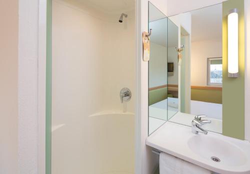 a bathroom with a sink and a mirror at ibis budget Southampton Centre in Southampton