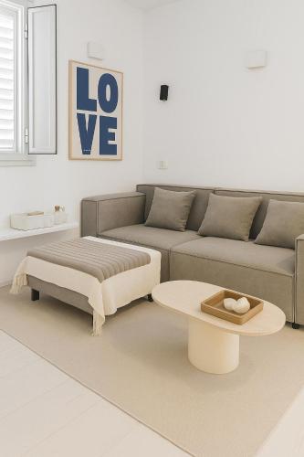 a living room with a couch and a coffee table at Marina Village in Herzliyya B