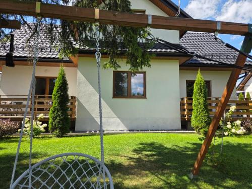 a swing in the yard of a house at Noclegi nad Czarną Orawą in Podwilk