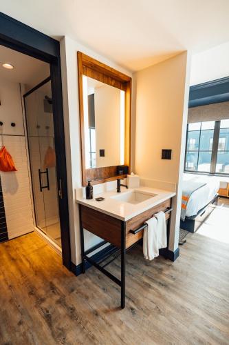 a bathroom with a sink and a large mirror at Hammetts Hotel in Newport
