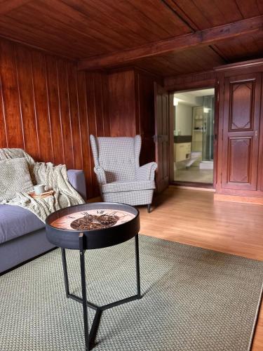 a living room with a couch and a table at NEU! Seepanorama, am See 15 min von Interlaken in Oberried