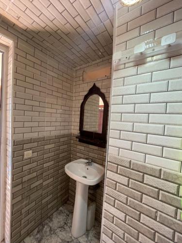 a bathroom with a sink and a mirror at Island surf house in Imsouane