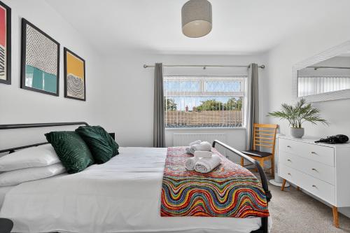 a bedroom with a bed with a teddy bear on a table at Hillsborough Home from Home, Garden and 2x Parking by StayByNumbers in Hillsborough