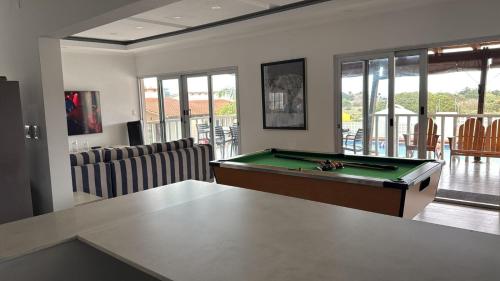 a living room with a pool table in it at Mar Bela Suites in Ubomo