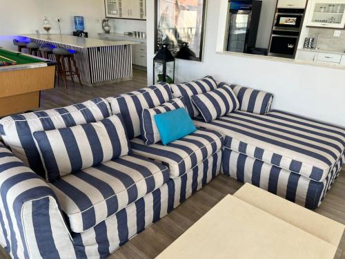 a blue and white couch in a living room at Mar Bela Suites in Ubomo