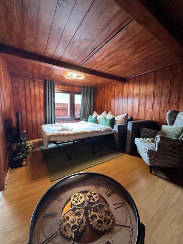 a living room with a bed and a table at NEU! Seepanorama, am See 15 min von Interlaken in Oberried
