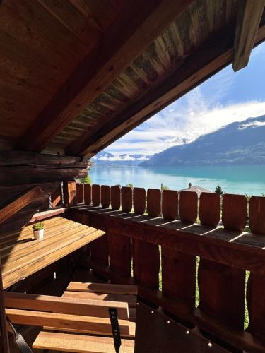 a table and chairs on a deck with a view of the ocean at NEU! Seepanorama, am See 15 min von Interlaken in Oberried
