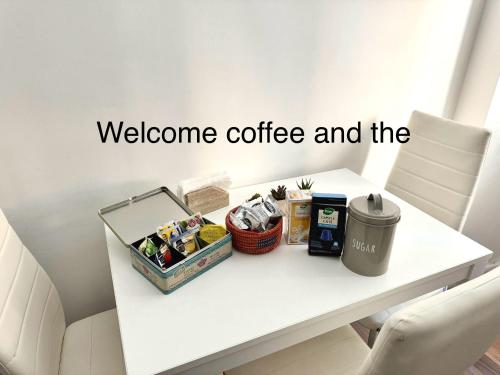a white table with a welcome coffee and the words at Gianicolo House in Rome