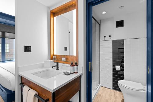 a bathroom with a sink and a toilet and a shower at Hammetts Hotel in Newport