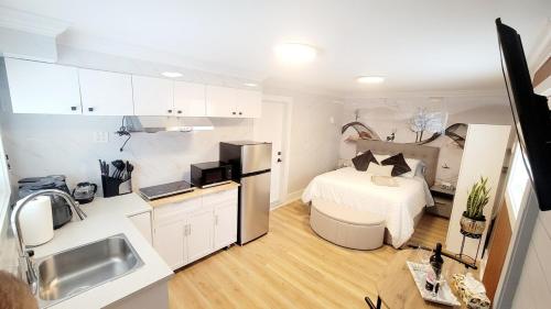 a small room with a bed and a kitchen at Secluded Bachelor Suite in Vancouver