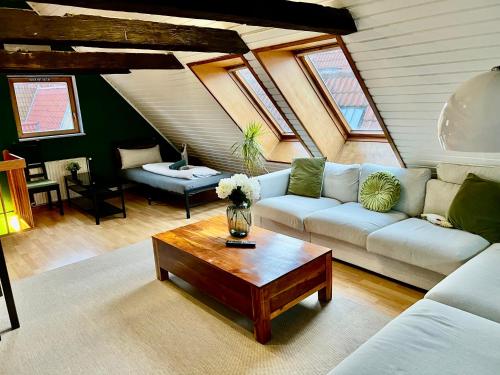a living room with a couch and a coffee table at Ferienwohnung Coco in Lübeck