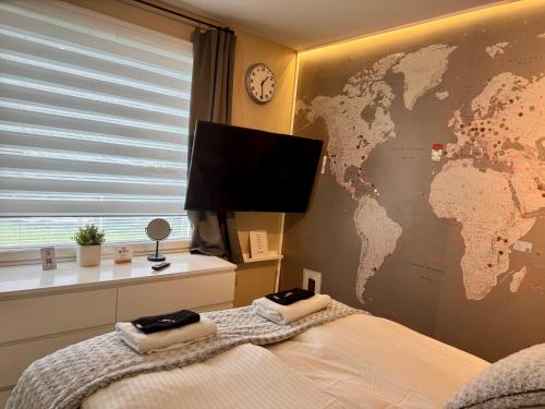 a bedroom with a map of the world on a wall at Design Guesthouse Laanila in Oulu