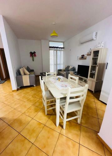 a living room with a white table and chairs at Golem Beach Apartment - Very Large - Self Check In - Parking Available in Golem