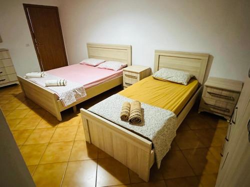 two beds in a room with at Golem Beach Apartment - Very Large - Self Check In - Parking Available in Golem