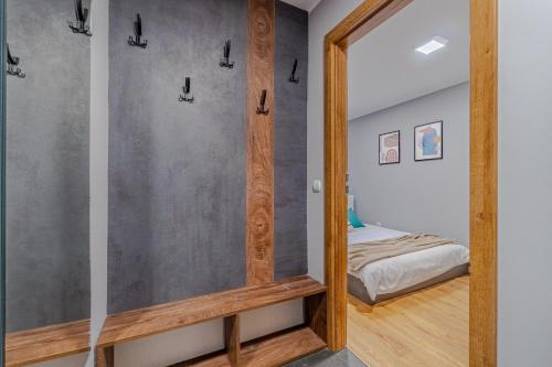 a bedroom with a mirror and a bed in a room at Apartament Lubliniec Centrum, PW Invest Home in Lubliniec