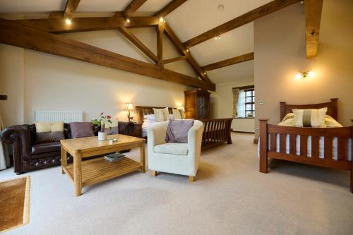 a living room with a couch and a table at Green Grove Country House in Malham